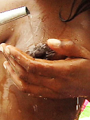 Sweety ebony girl relaxing with garden hose