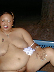 Fat chocolate woman posing outdoor